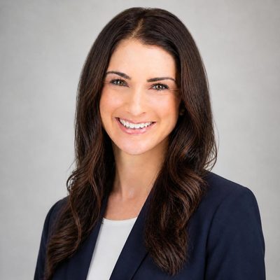 Kim Priddy, founder of KPi, smiling in a navy blazer